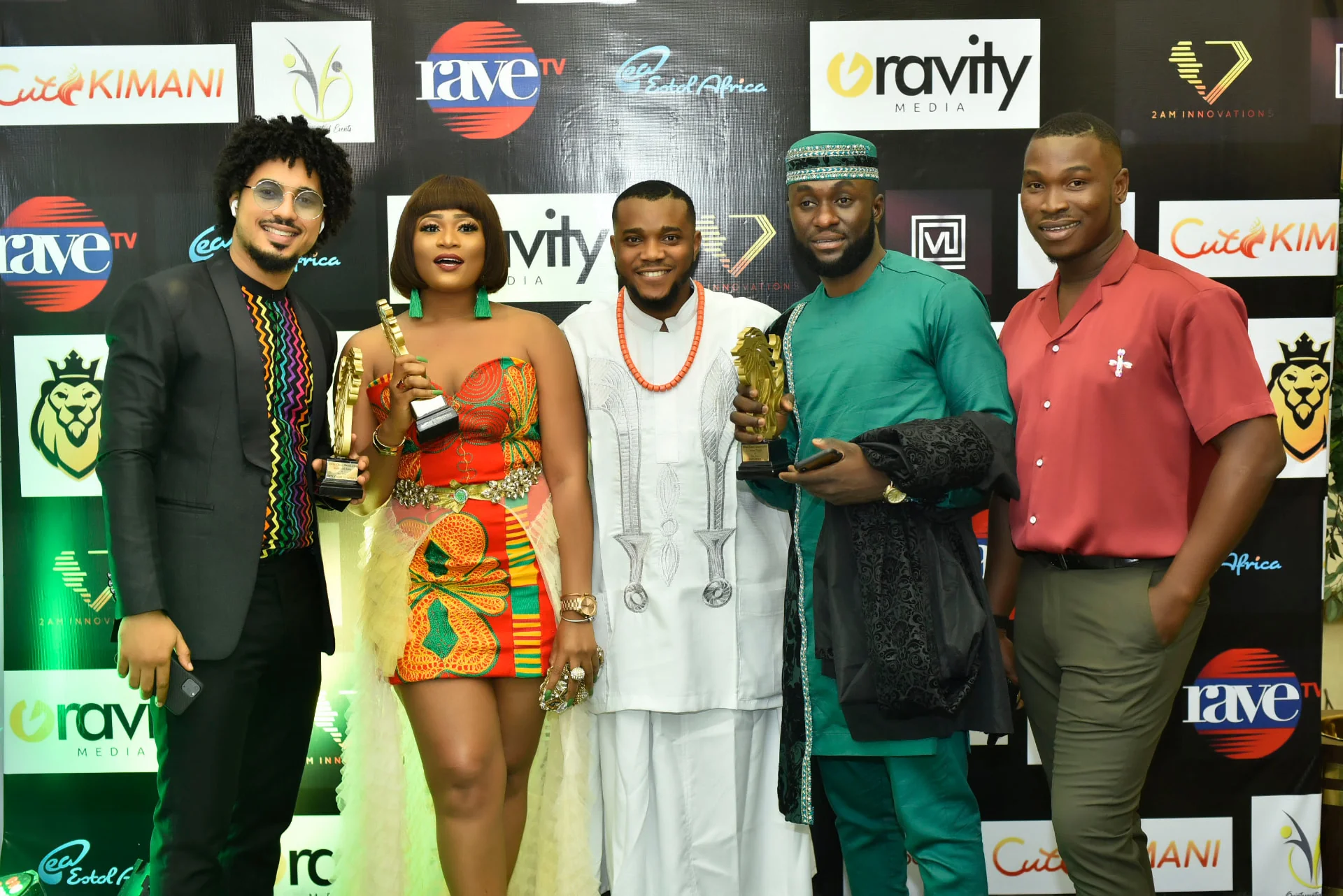 Five guests, three holding Africa Choice Awards trophies, in front of a sponsor backdrop